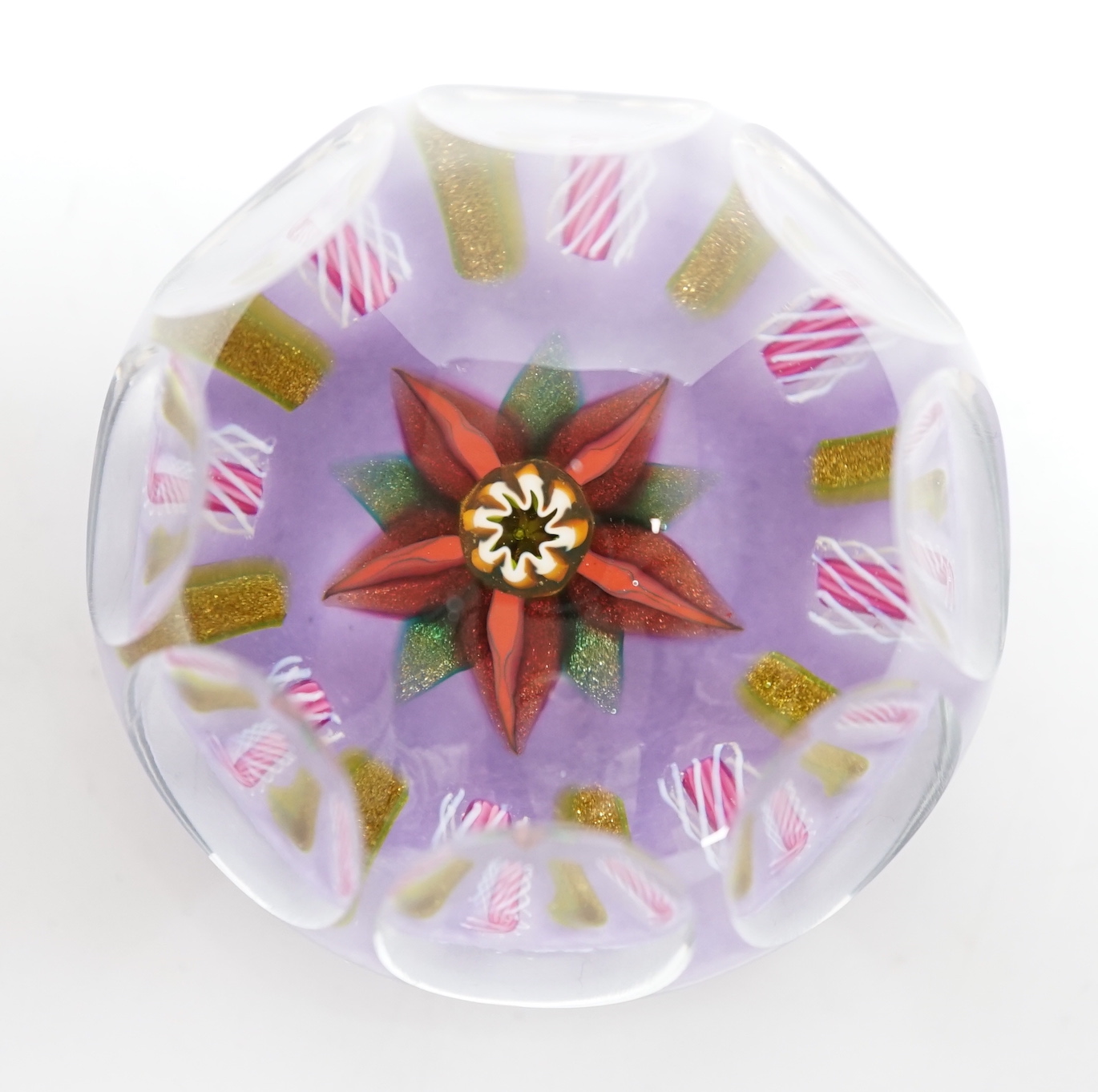 A Paul Ysart faceted ‘flower’ glass paperweight, Harland period, the central flower within aventurine and latticino spokes on a violet ground, PY paper label to base, 6.5cm